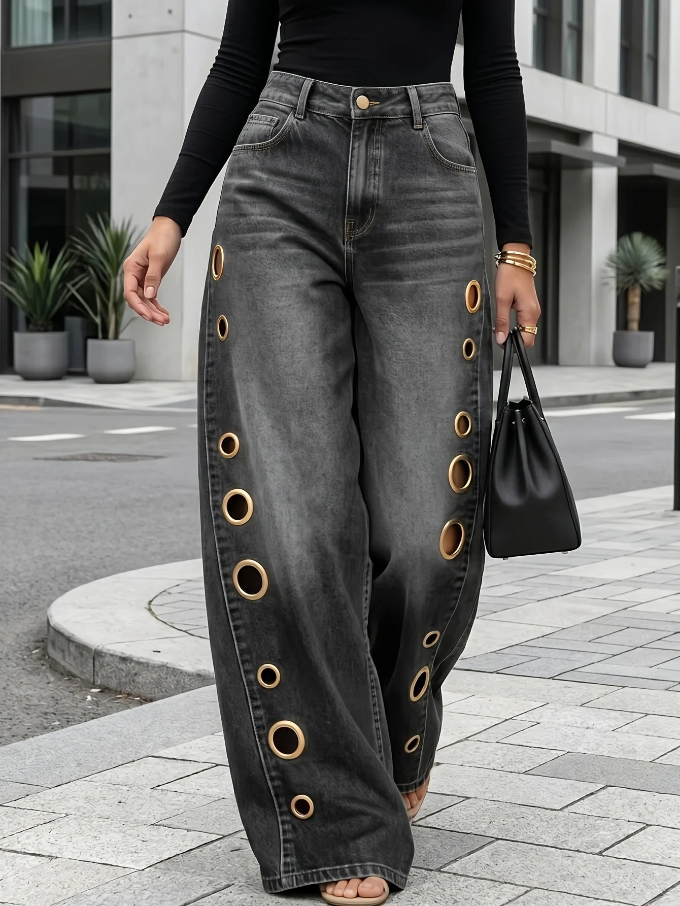 Retro-style wide-leg jeans with metallic eyelets, high-waisted, loose, floor-length fit, gradient eyelets of varying sizes on both sides, distressed washed finish, classic front and back pockets, perfect for everyday casual w